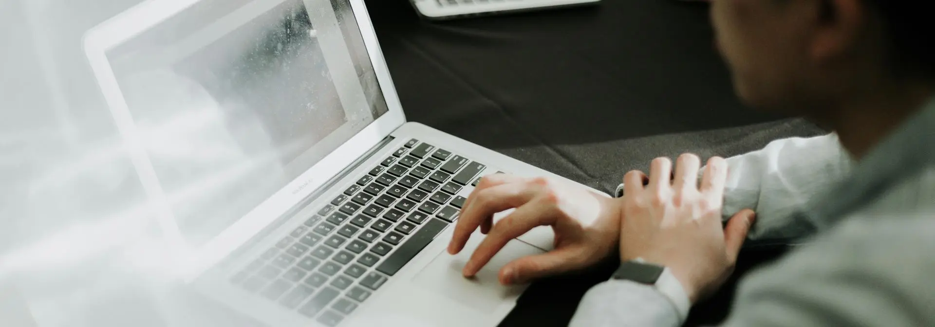 A student looking at the laptop screen