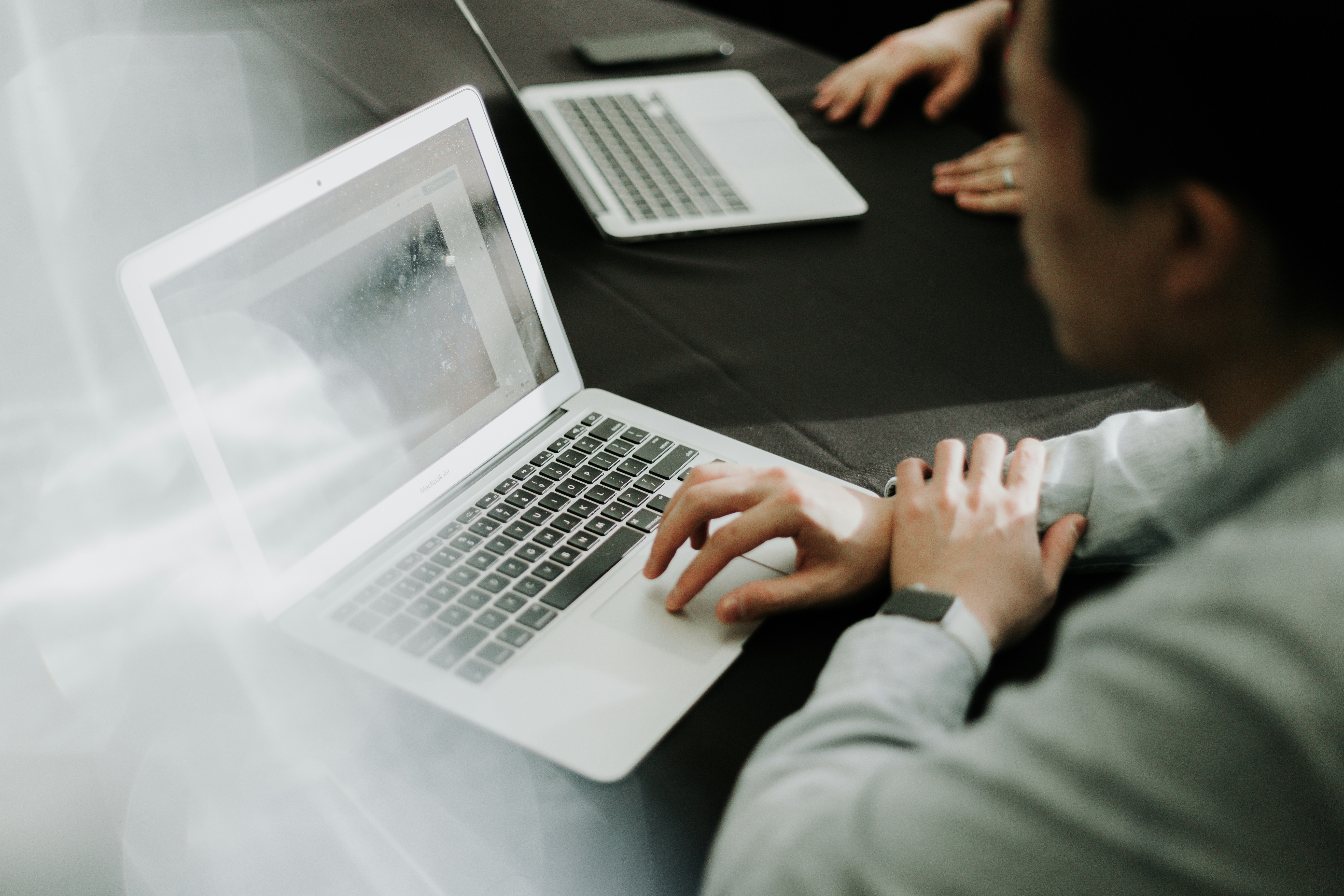 A student looking at the laptop screen
