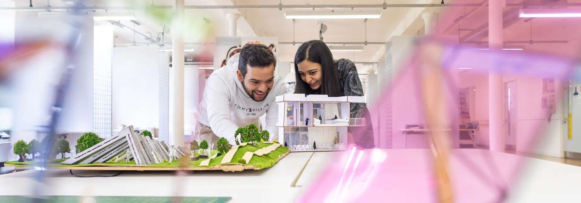 Two students looking at an object together