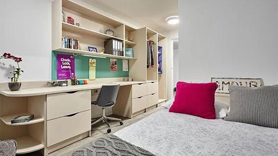 Room showing bed, desk, shelving and wardrobe