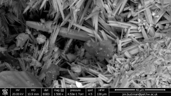 Aragonite crystals infilling pore space within sandstone
