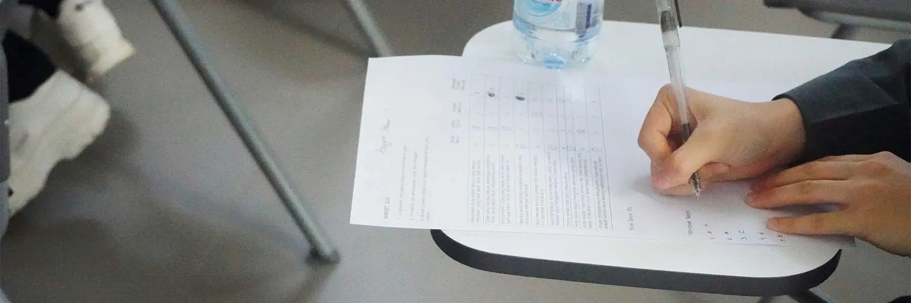 A student writes on an exam paper