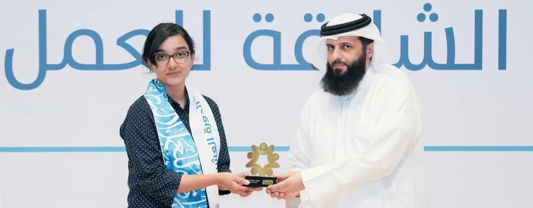 Megna Rajagopal being presented with an award