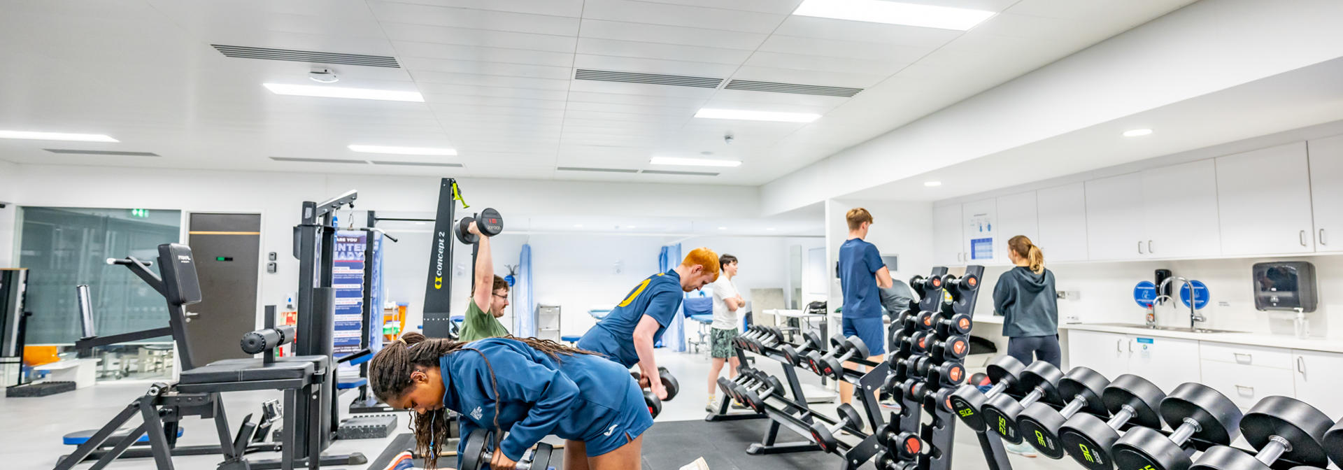 A group of students using weights in the Oriam gymnasium