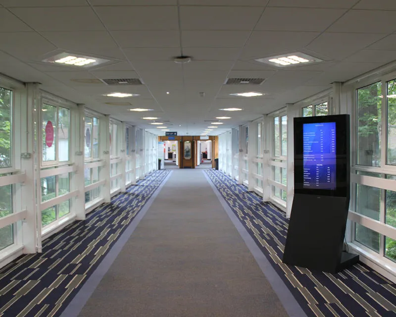 Long carpeted walkway with windows along both sides