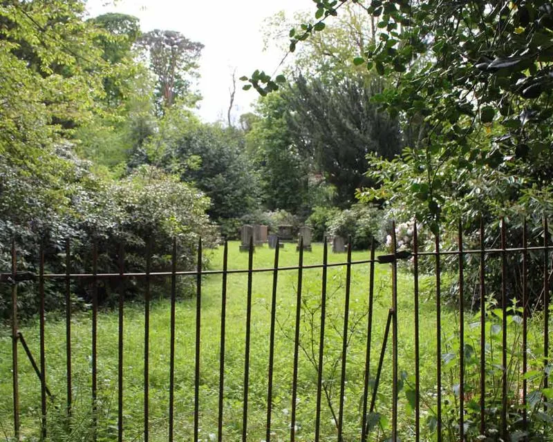 Headstones beyond iron railings