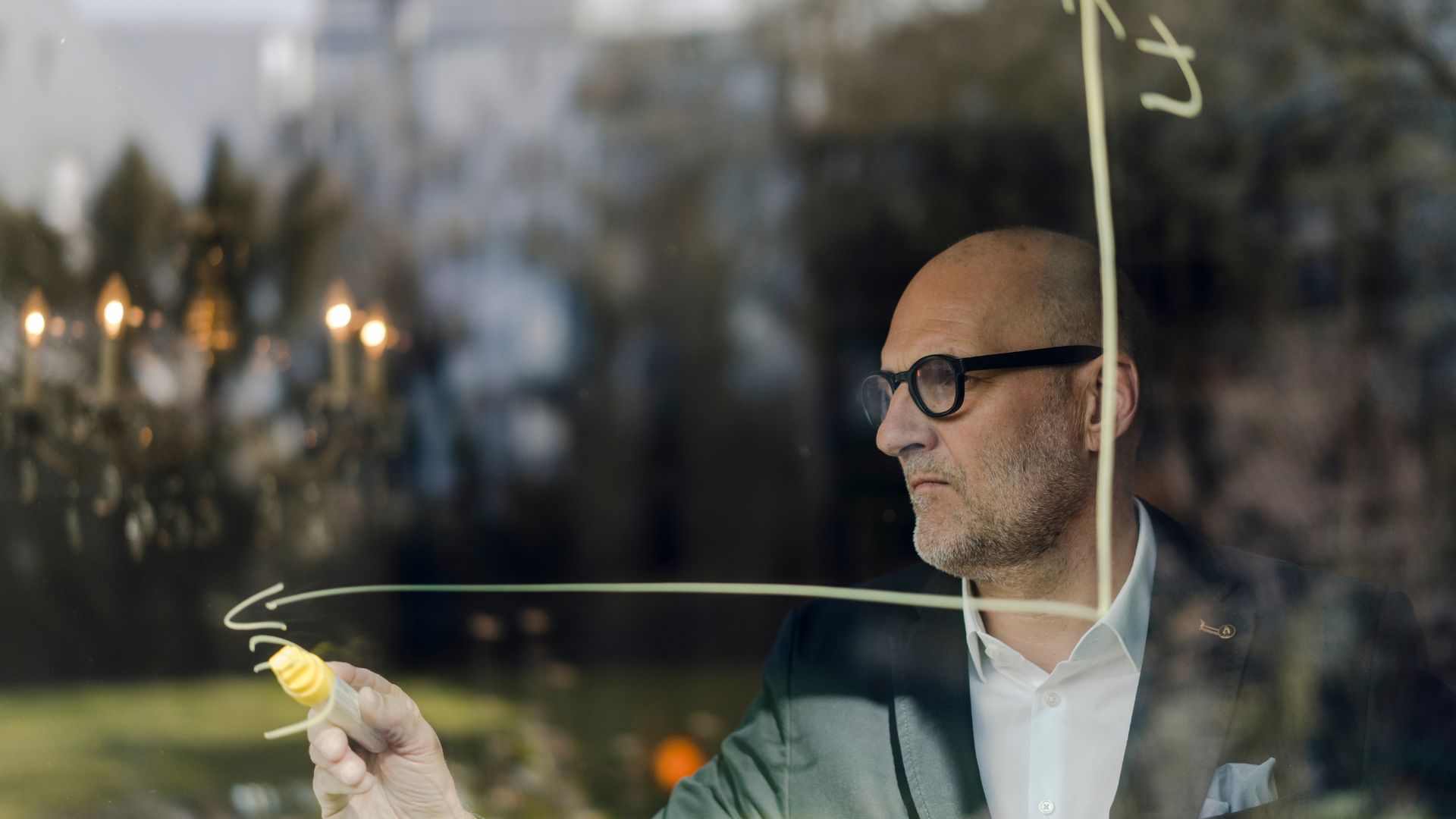 Lecturer writing on clear board