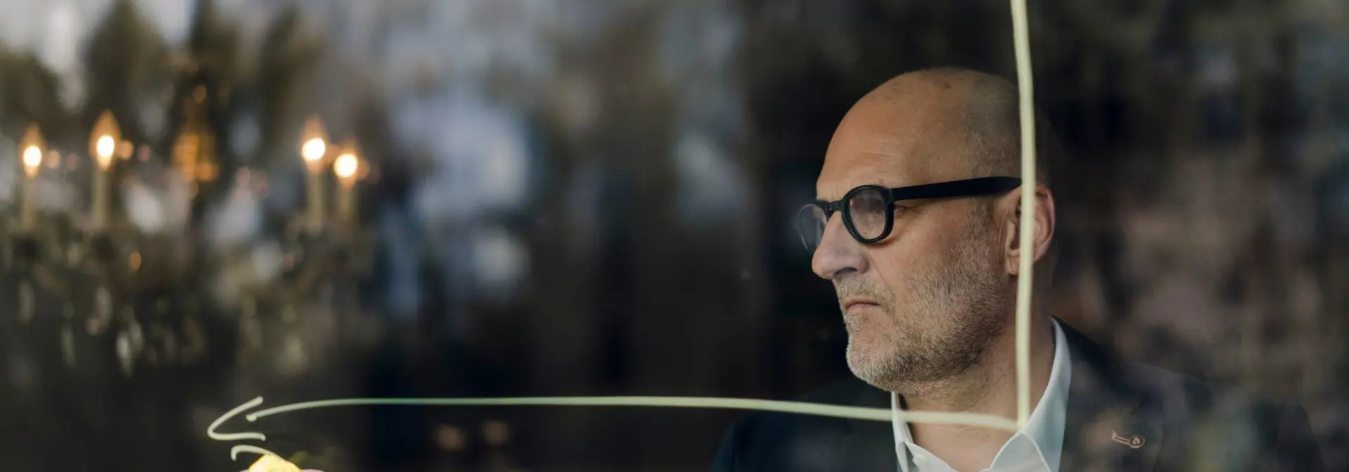 Lecturer writing on clear board