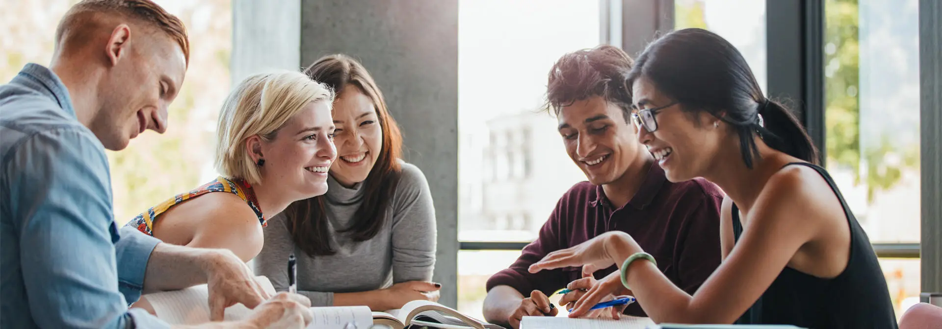 Five individuals working together and in discussion.