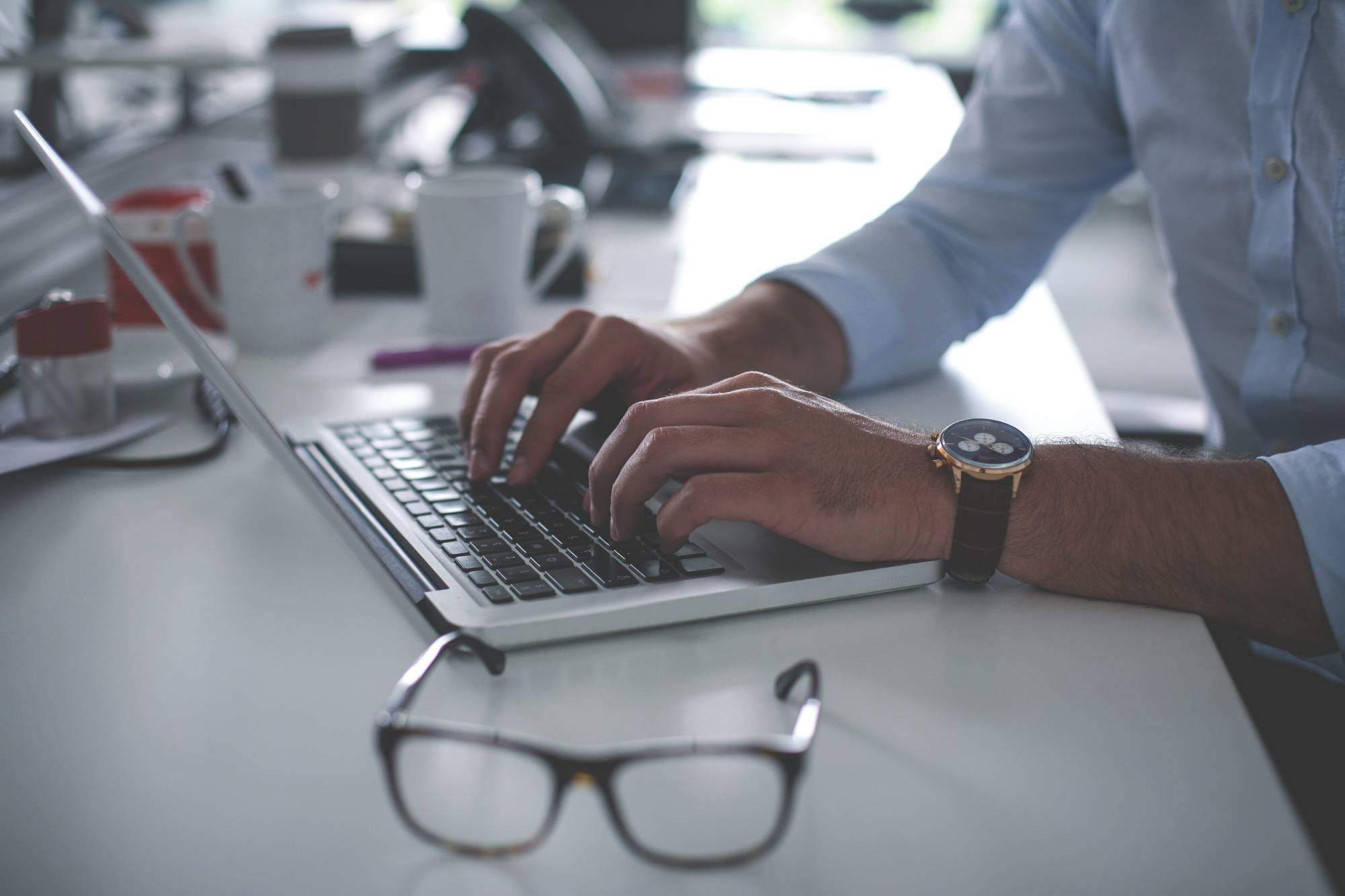 Man typing on a computer. 