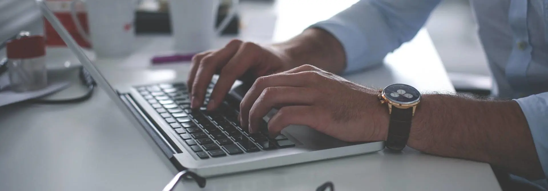 Man typing on a computer.