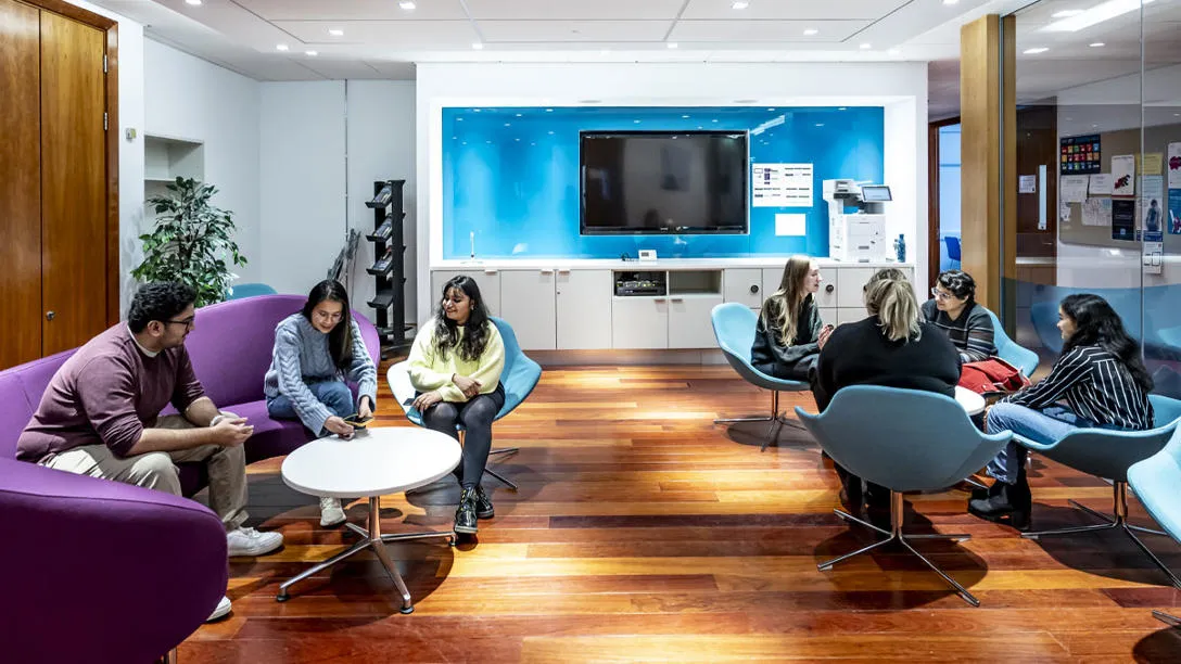 A group of students sit chatting in the Edinburgh Business School