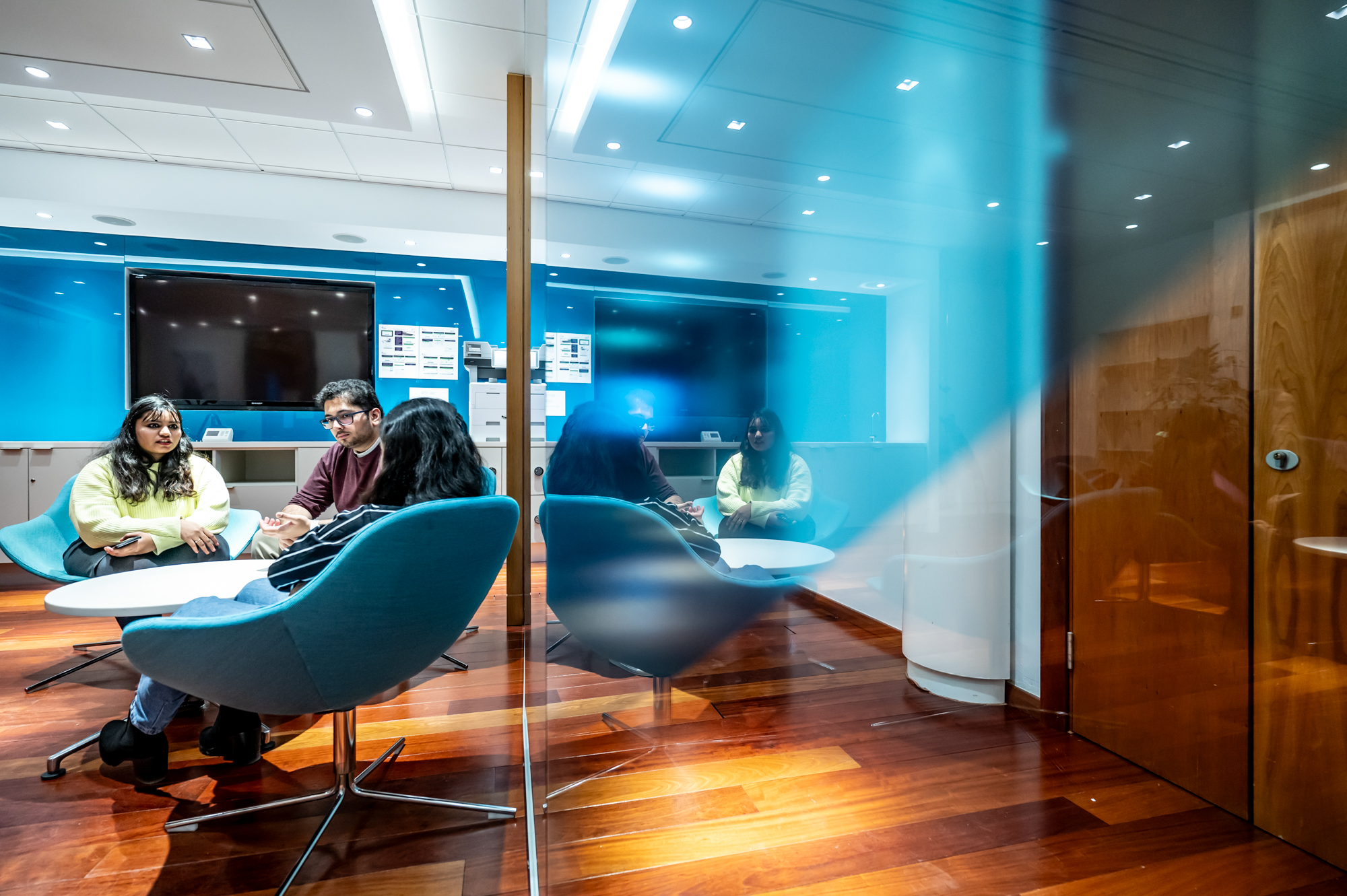 Students take a break in the Edinburgh Business School break out area seating