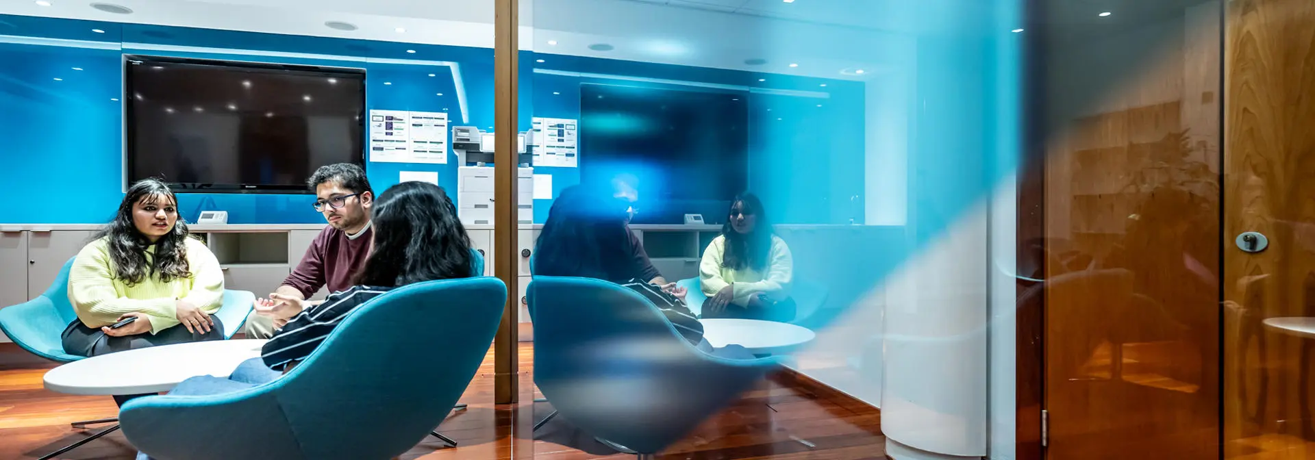 Students take a break in the Edinburgh Business School break out area seating