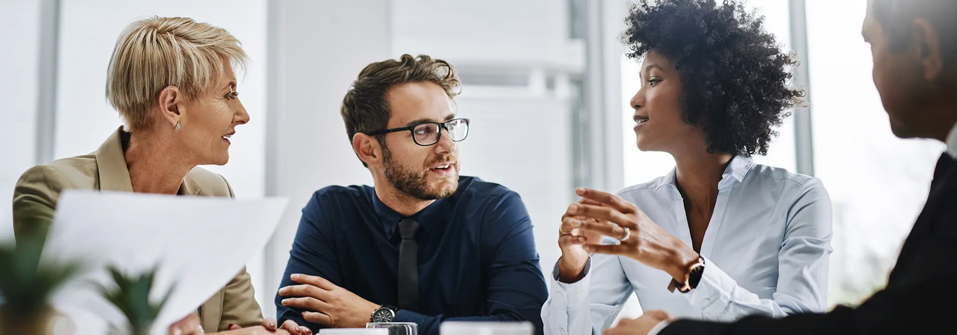 Four business people having a meeting over coffee.