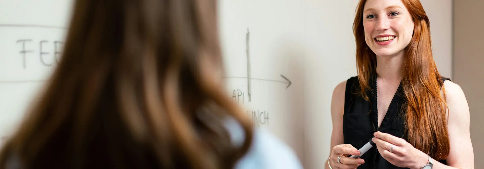A student in front of the whiteboard
