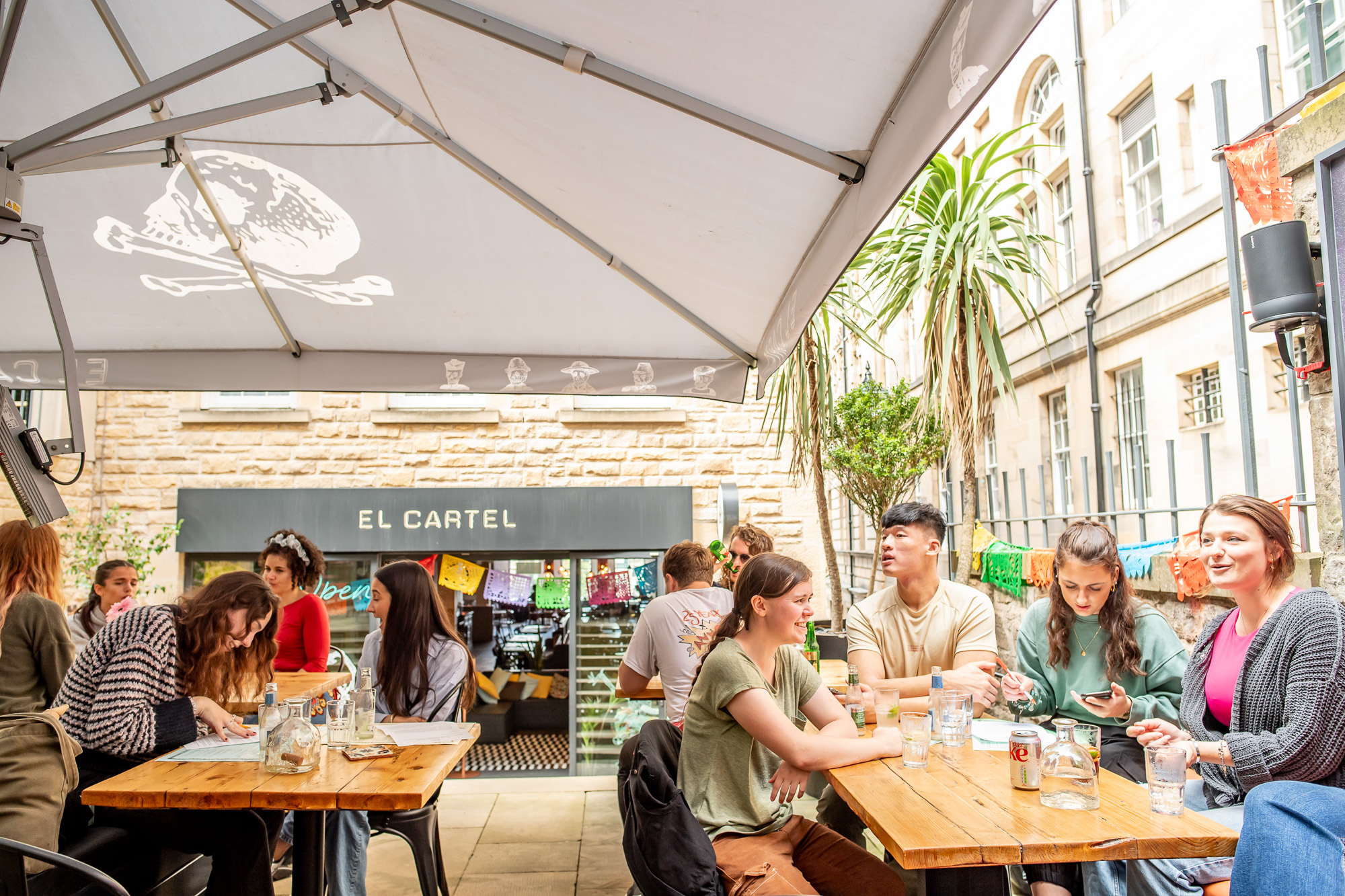 Students socialising outside at a pub.
