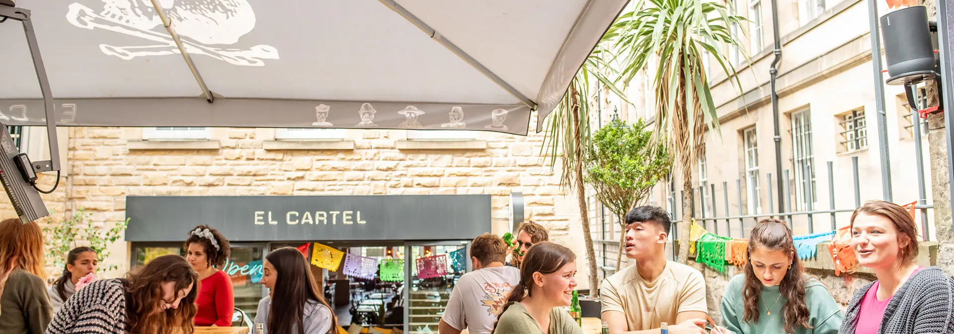 Students socialising outside at a pub.