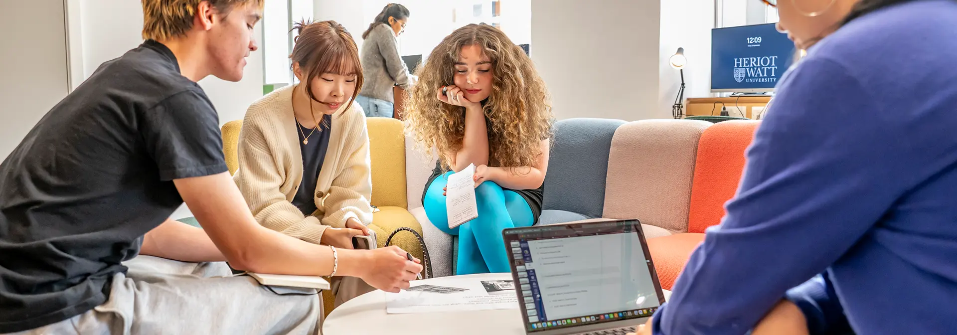Four students working around a small round table