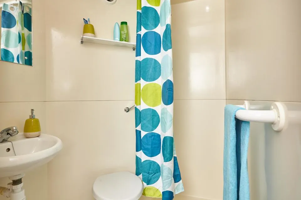 Brightly coloured shower curtain in an en-suite bathroom