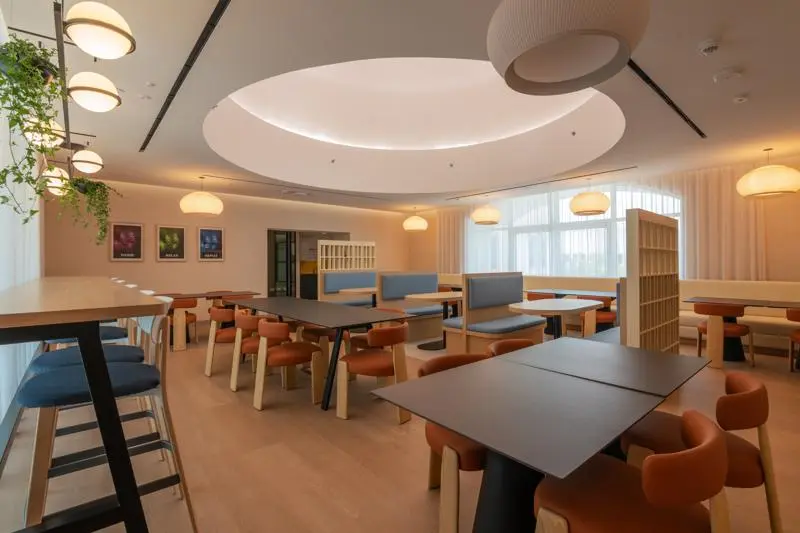 colurful tables and chairs in a square room with a dome ceiling
