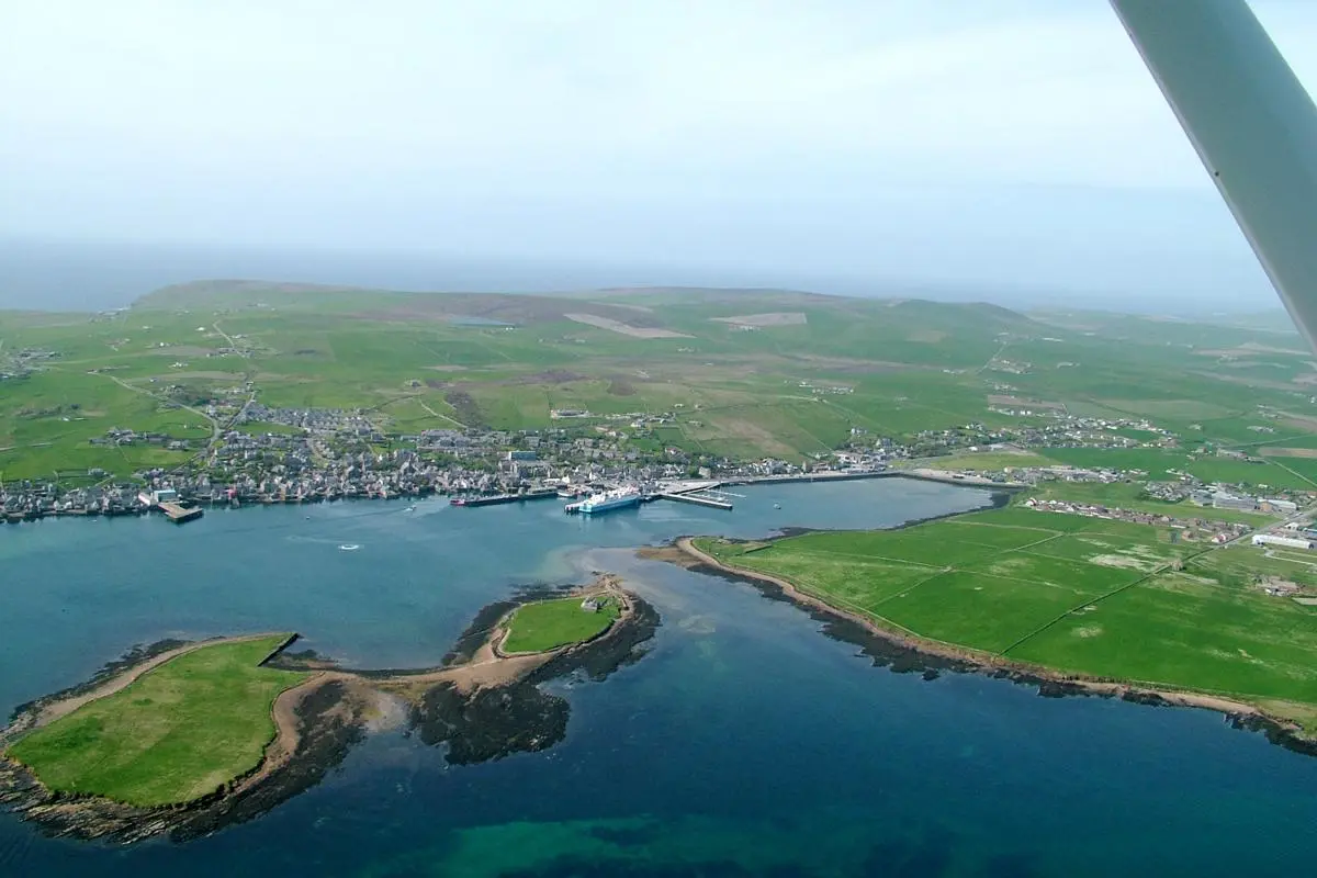 A faraway view of Orkney town and coastline