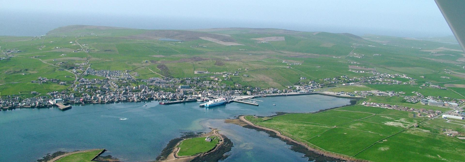A faraway view of Orkney town and coastline