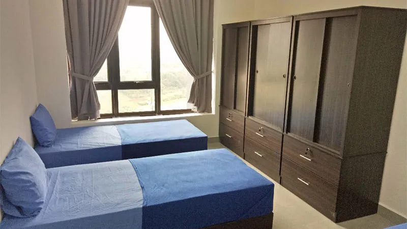 Bedroom showing two beds, wardrobe and window