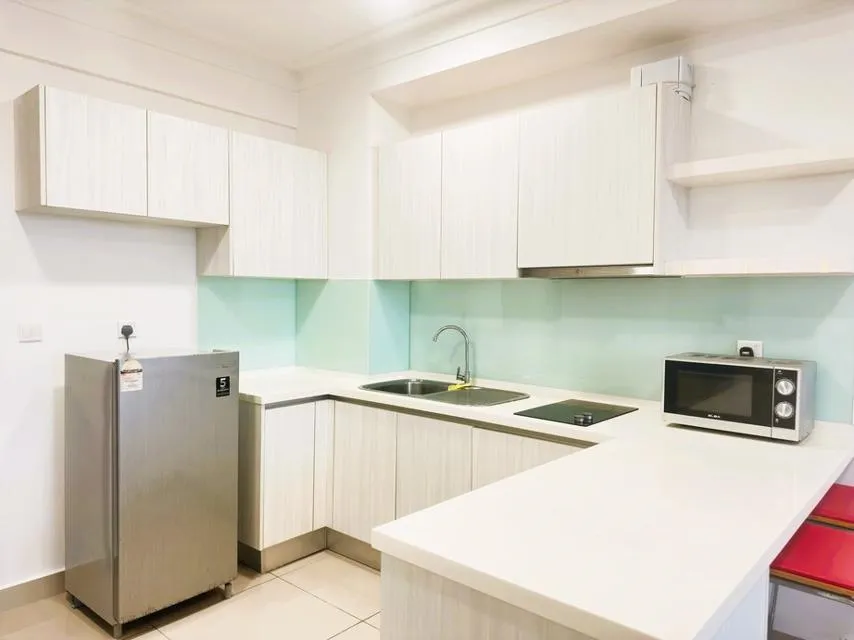 Kitchen and dining area, showing cupboards, worktops, microwave, sink, fridge and stools
