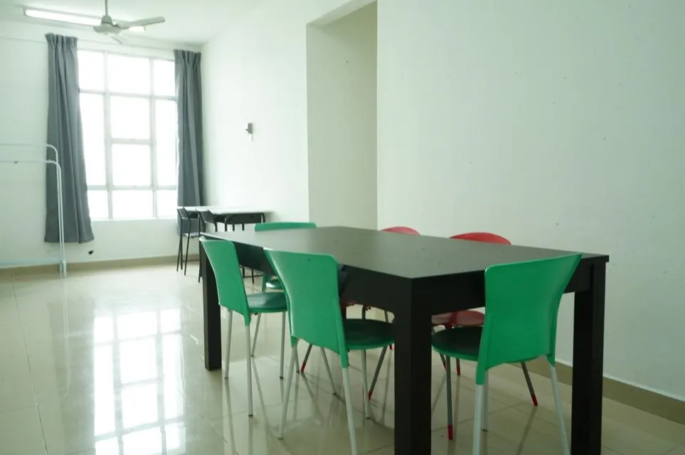 Living area with table and chairs, big window and tiled floor