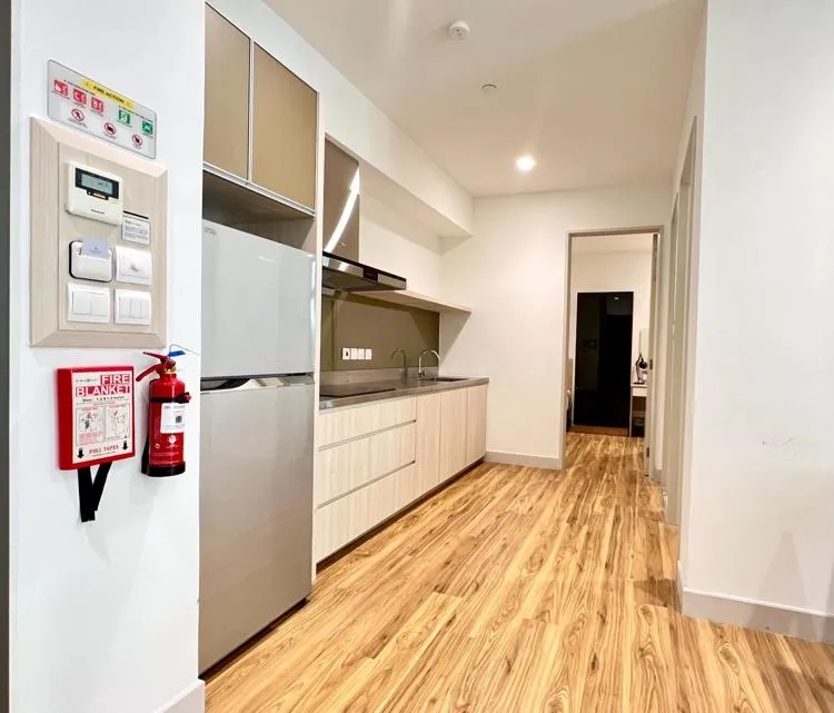 Living hall and kitchen, showing wooden floot and cupboards