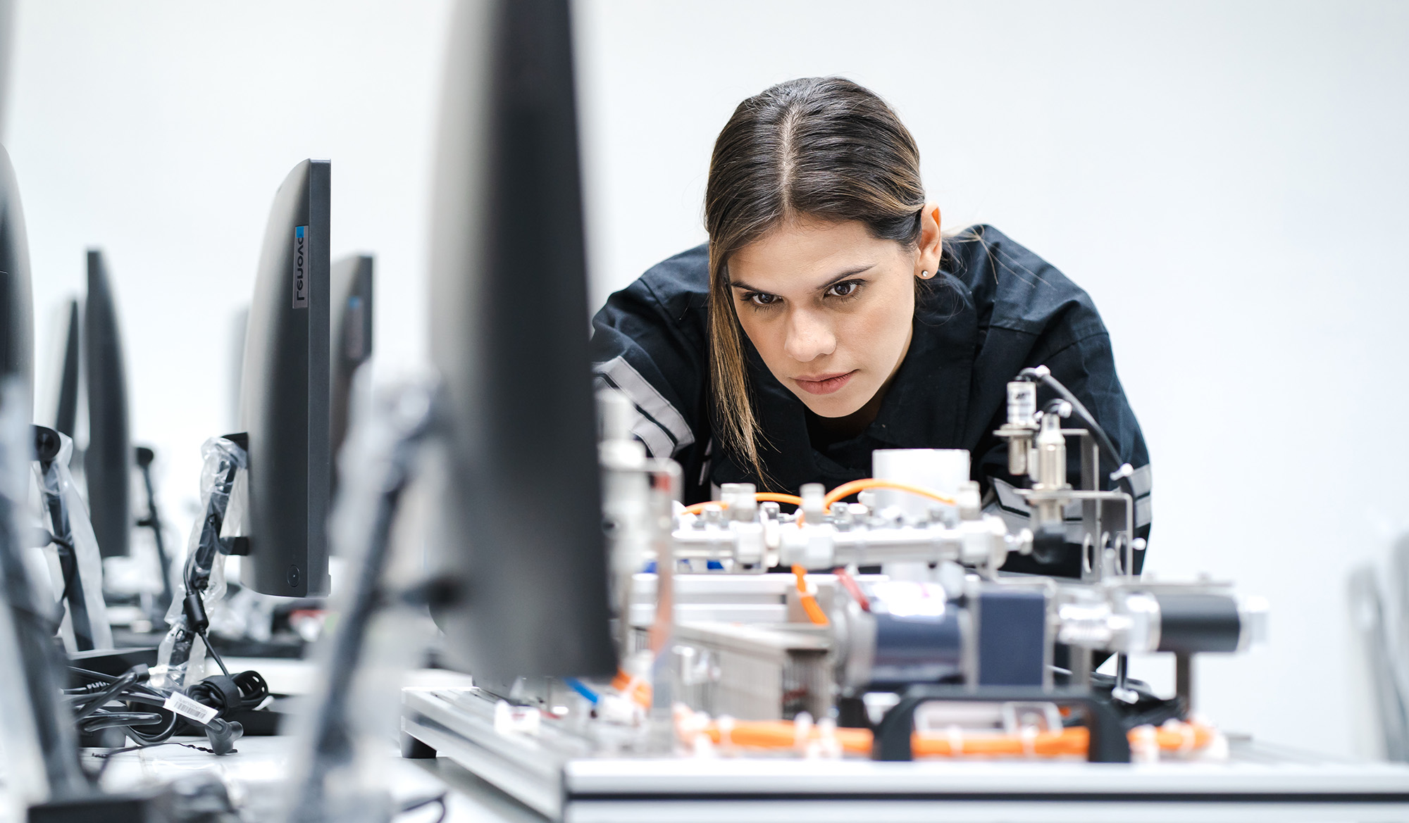 A student works on a device in a computer lab.