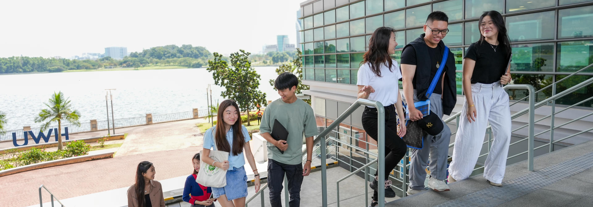 Students at Heriot-Watt University Malaysia walking up the steps at the campus.