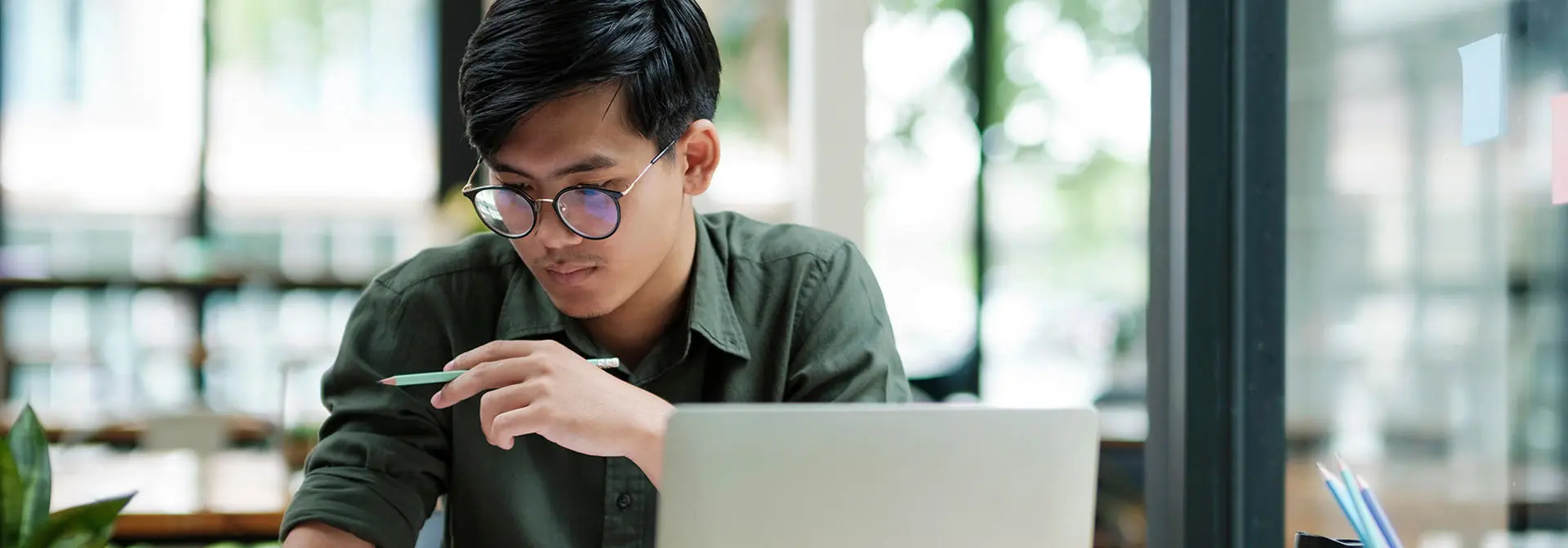 Student works on a laptop reviewing documents.