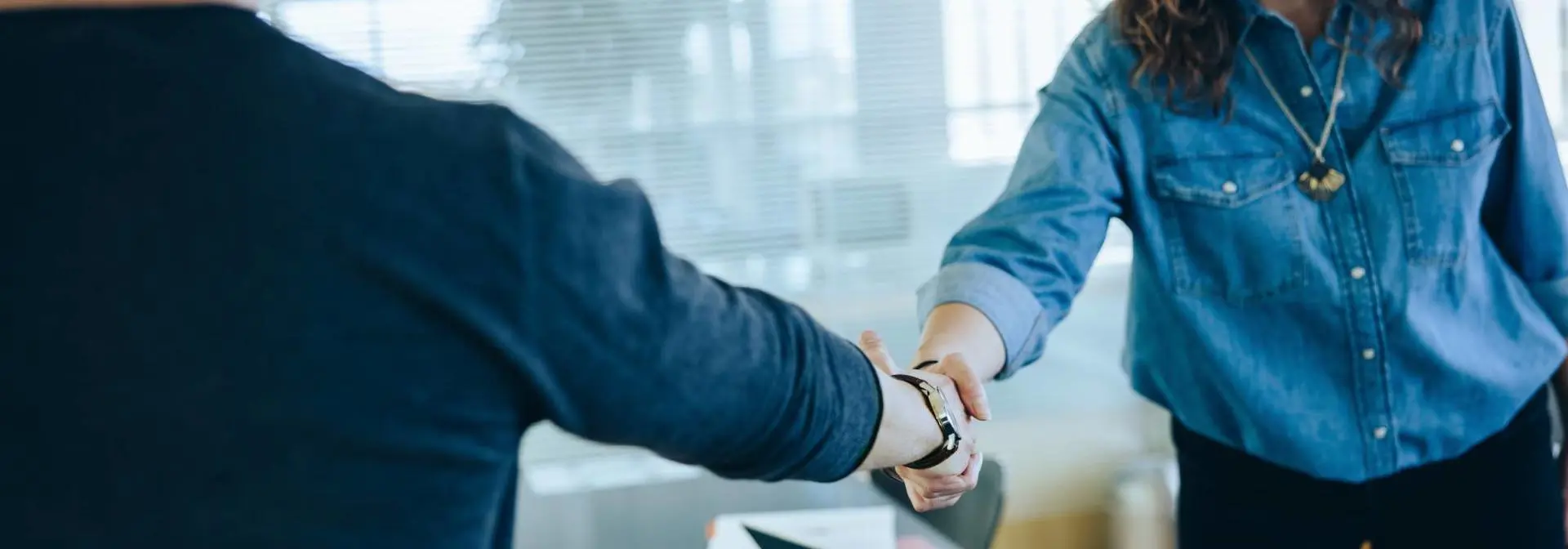 Two people meet and shaking hands.
