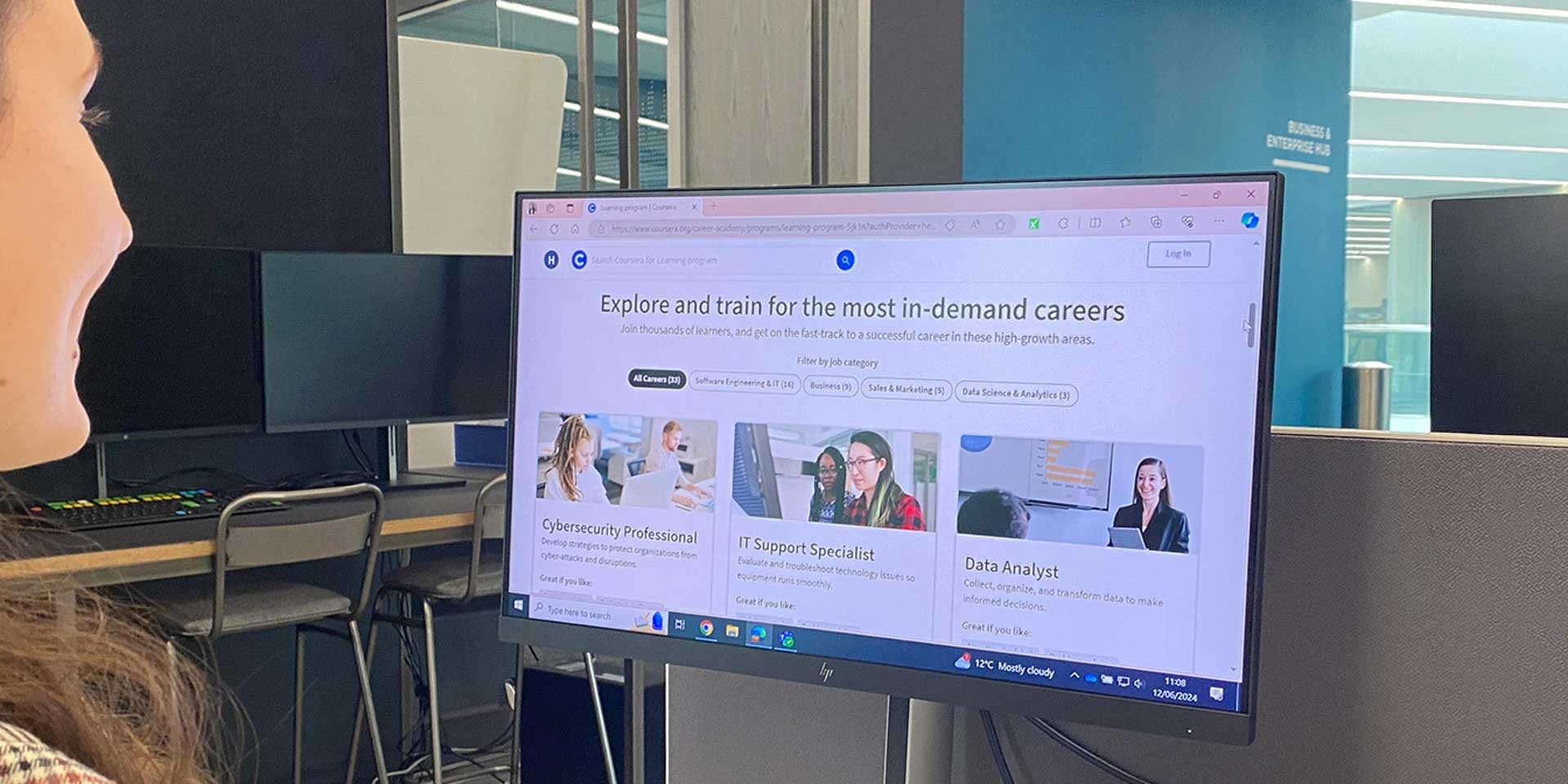 A student looking at a computer monitor