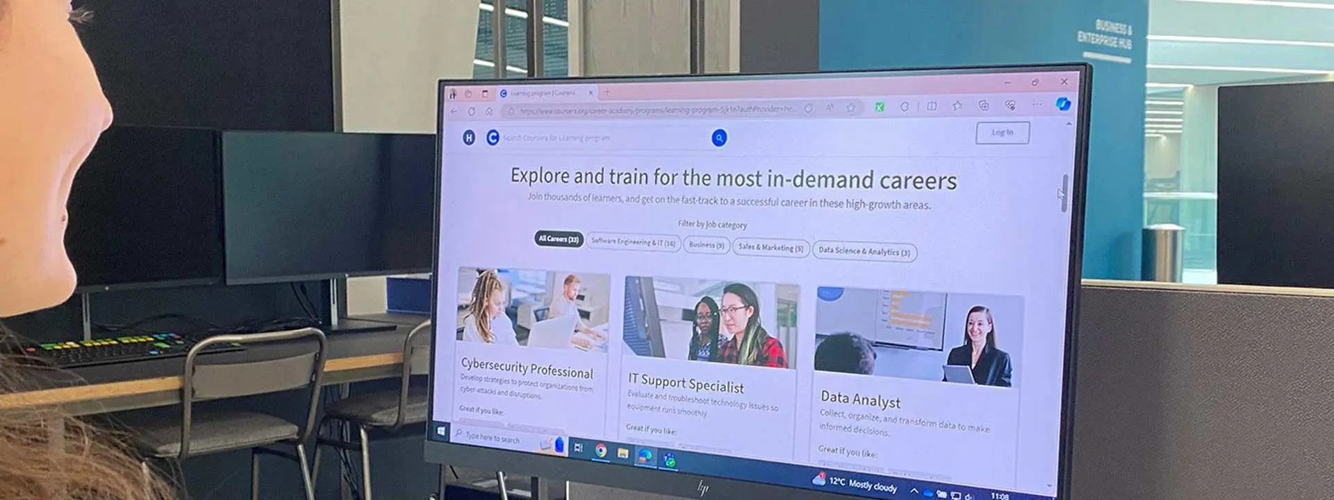 A student looking at a computer monitor