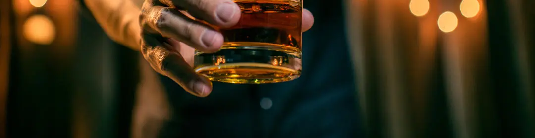 A glass of whisky being poured