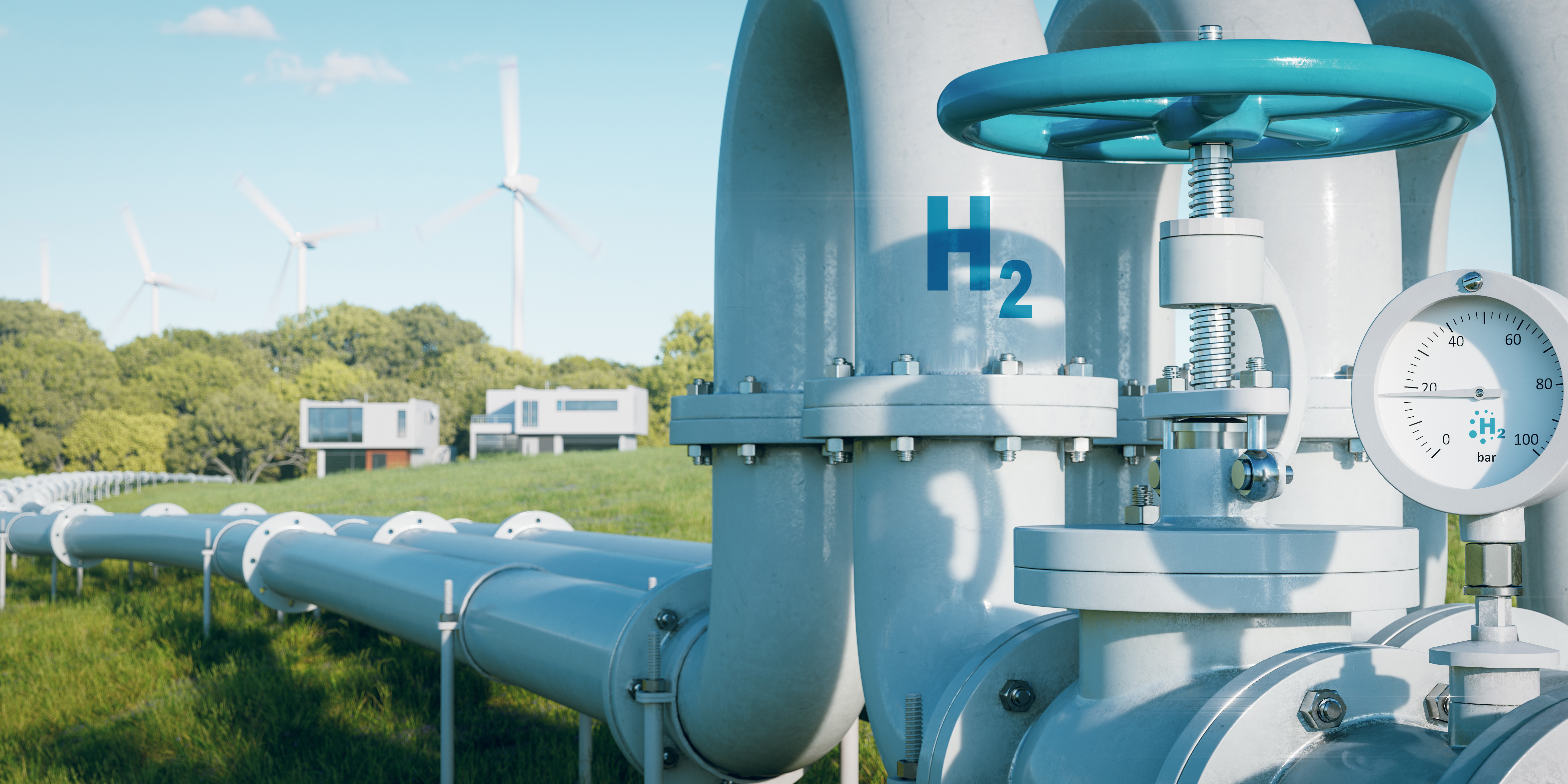 Close up of large grey hydrogen pipeline snaking into distance across a field