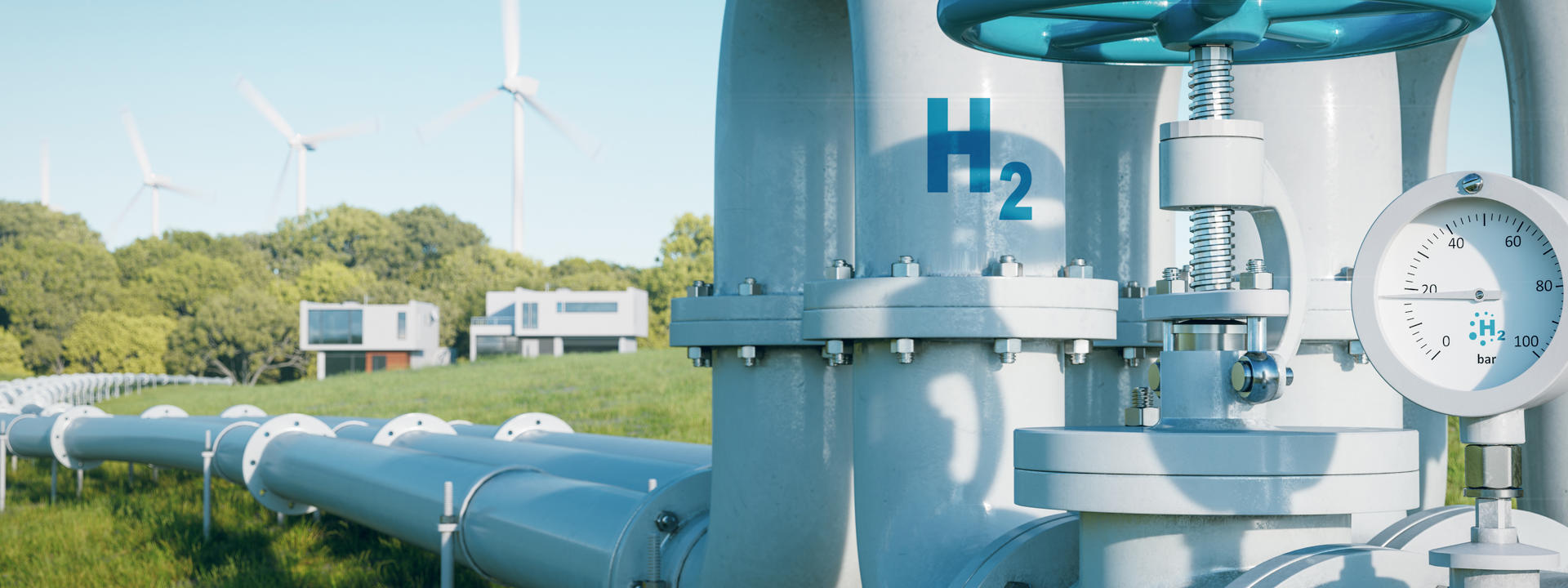 Close up of large grey hydrogen pipeline snaking into distance across a field