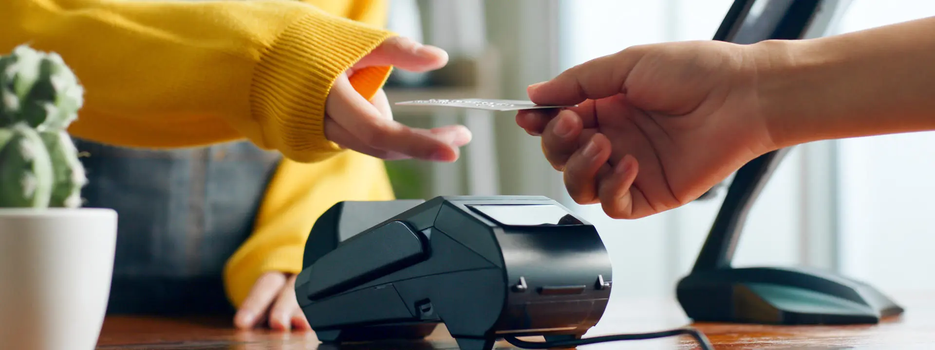 Customer using credit card for payment to owner at cafe restaurant