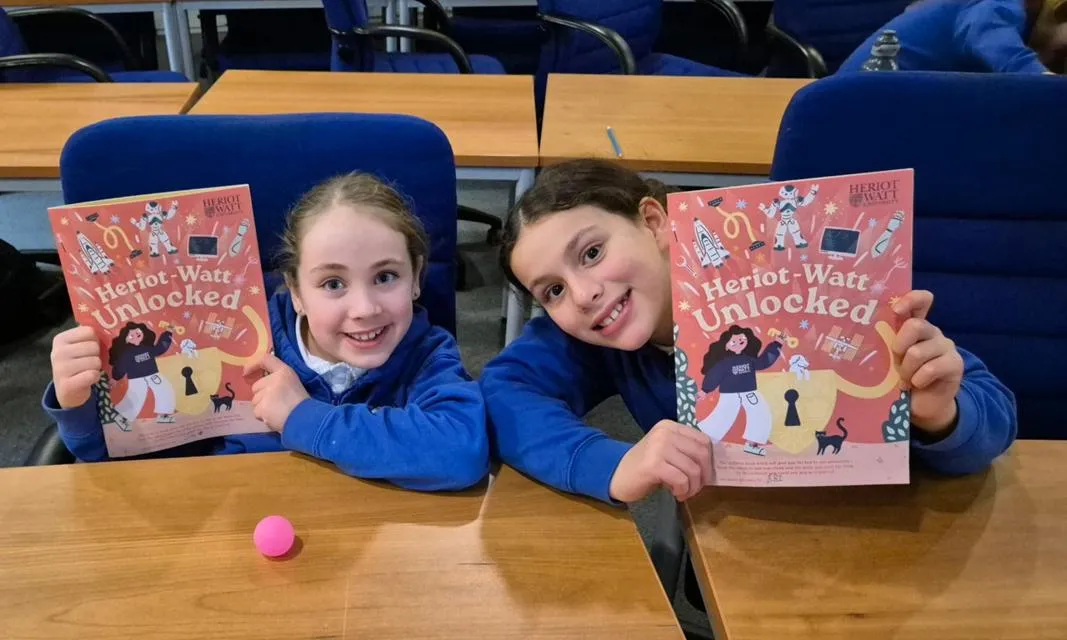 School children with the Heriot-Watt Unlocked booklet.
