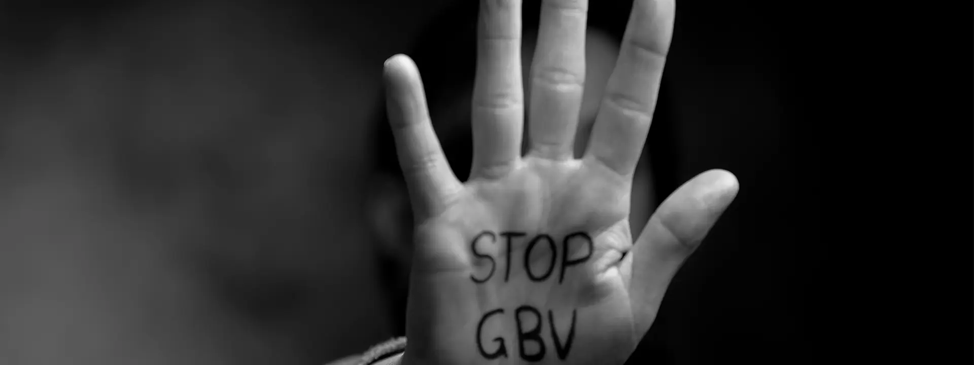 A hand with 'stop now' written on it in marker pen