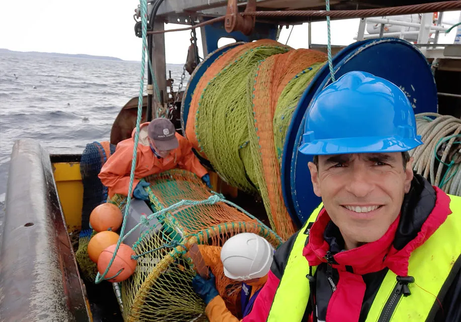 Dr Paul Fernandes, professor of fisheries at sea on a fishing boat.