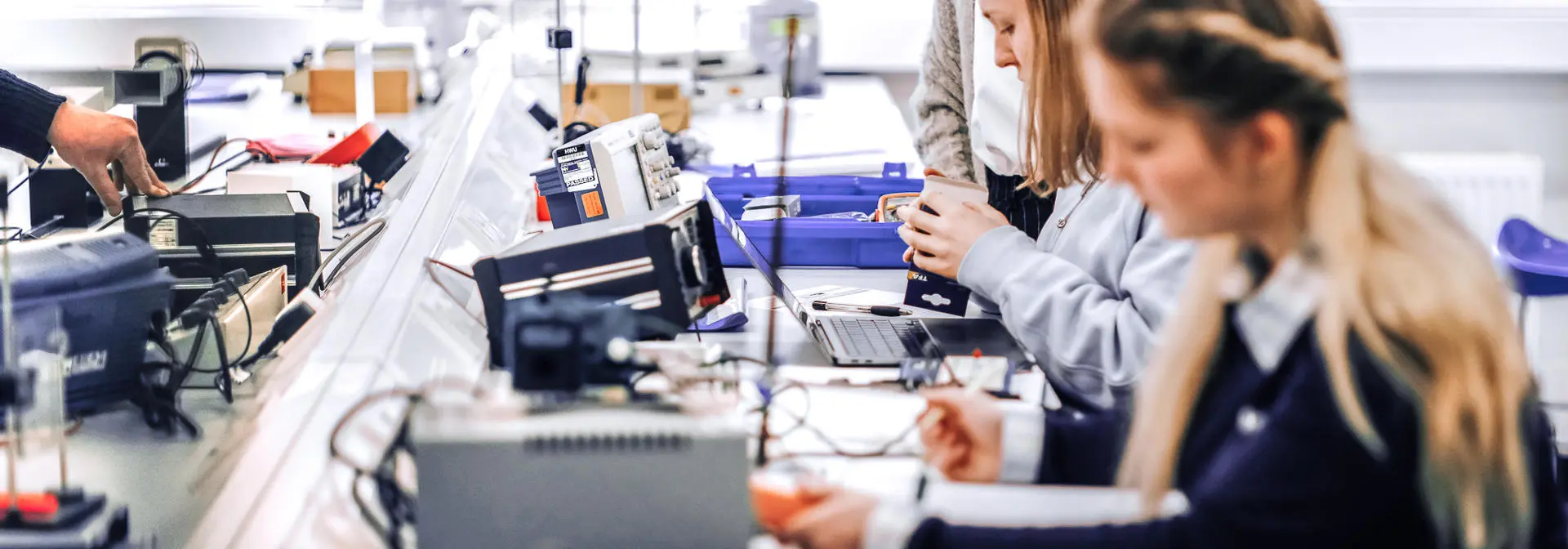 Female physics students working on electrical current experiment