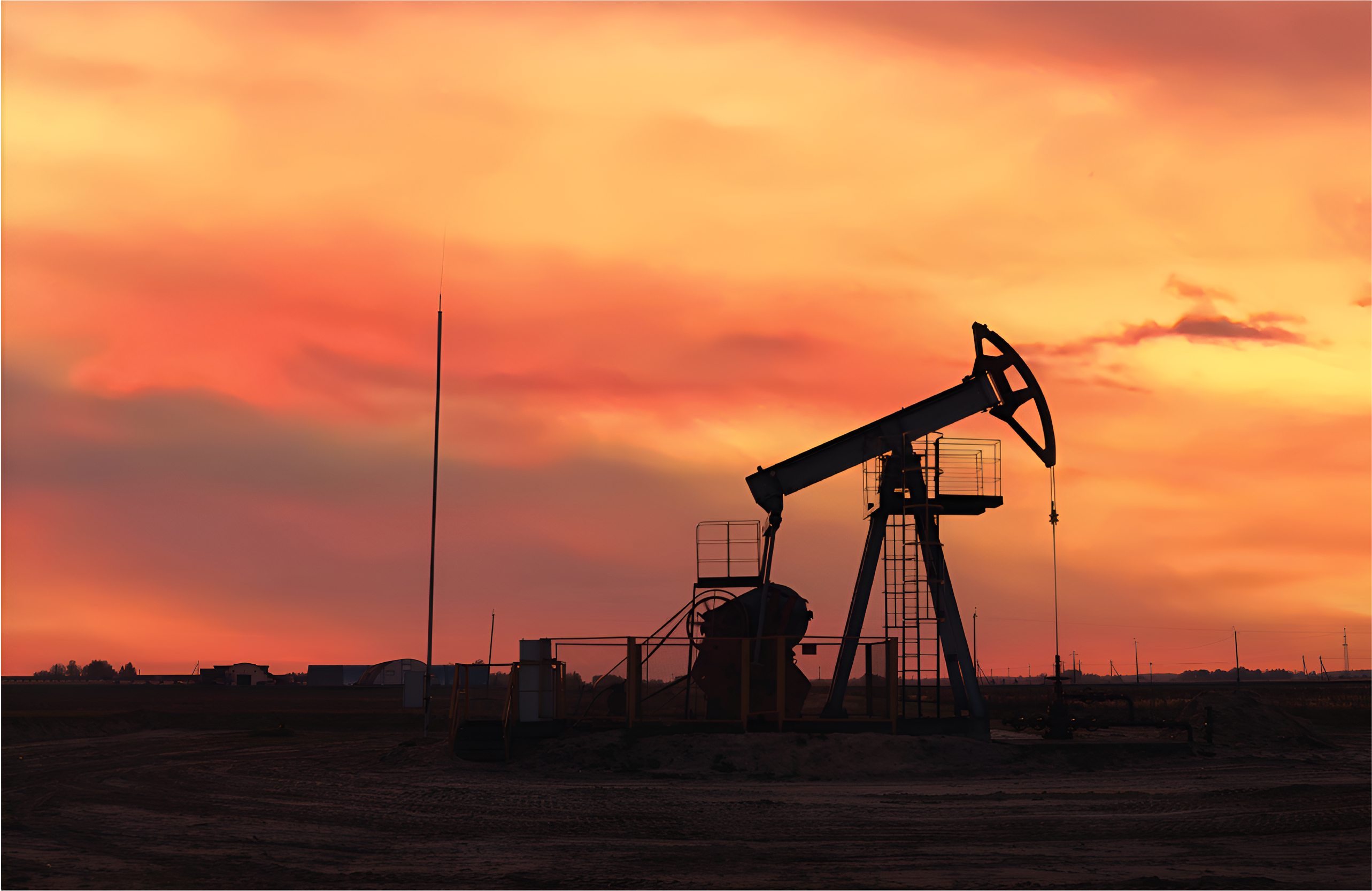 oil mining rig in front of a sunset
