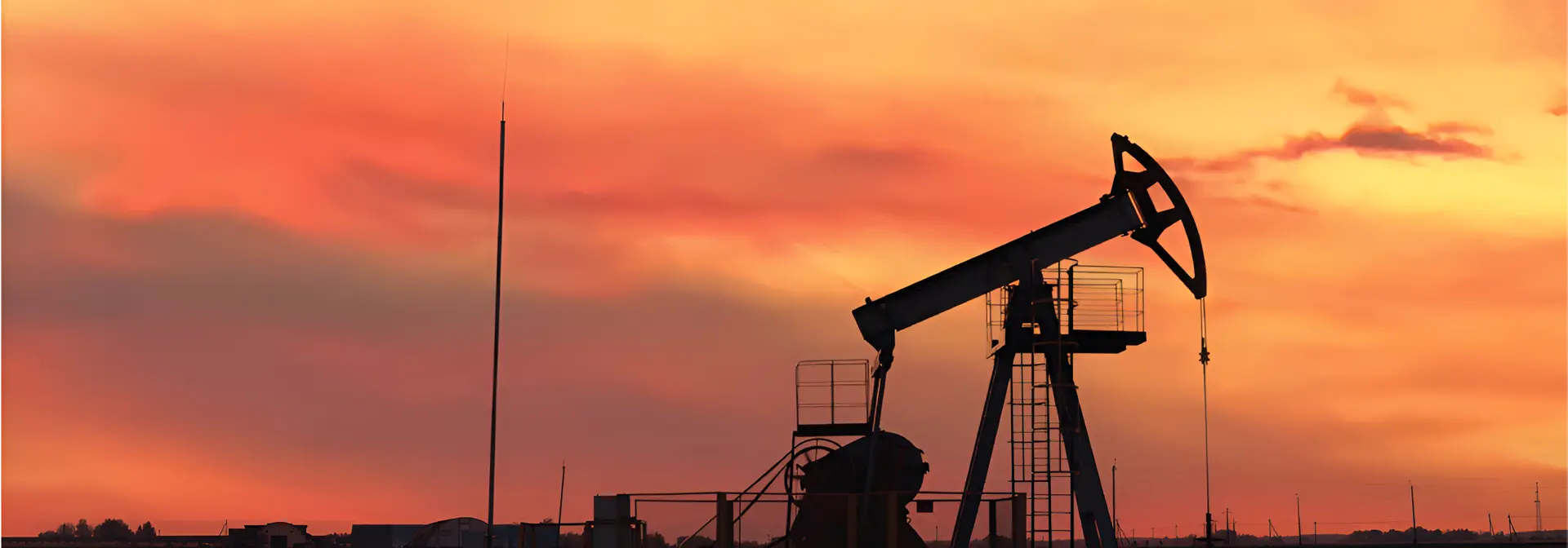oil mining rig in front of a sunset
