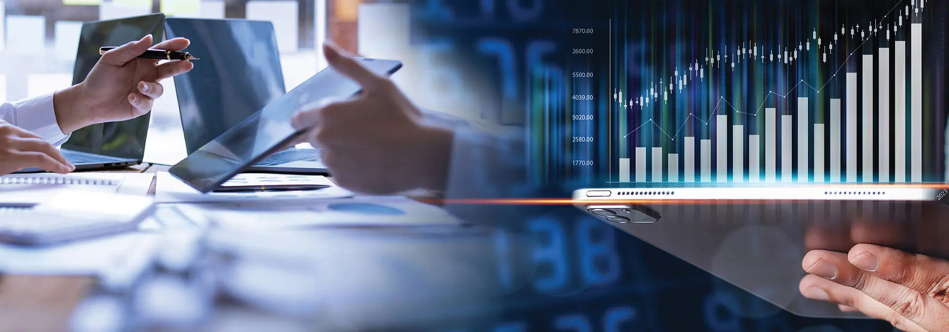 Two colleagues review a digital display featuring graphs and numerical information.