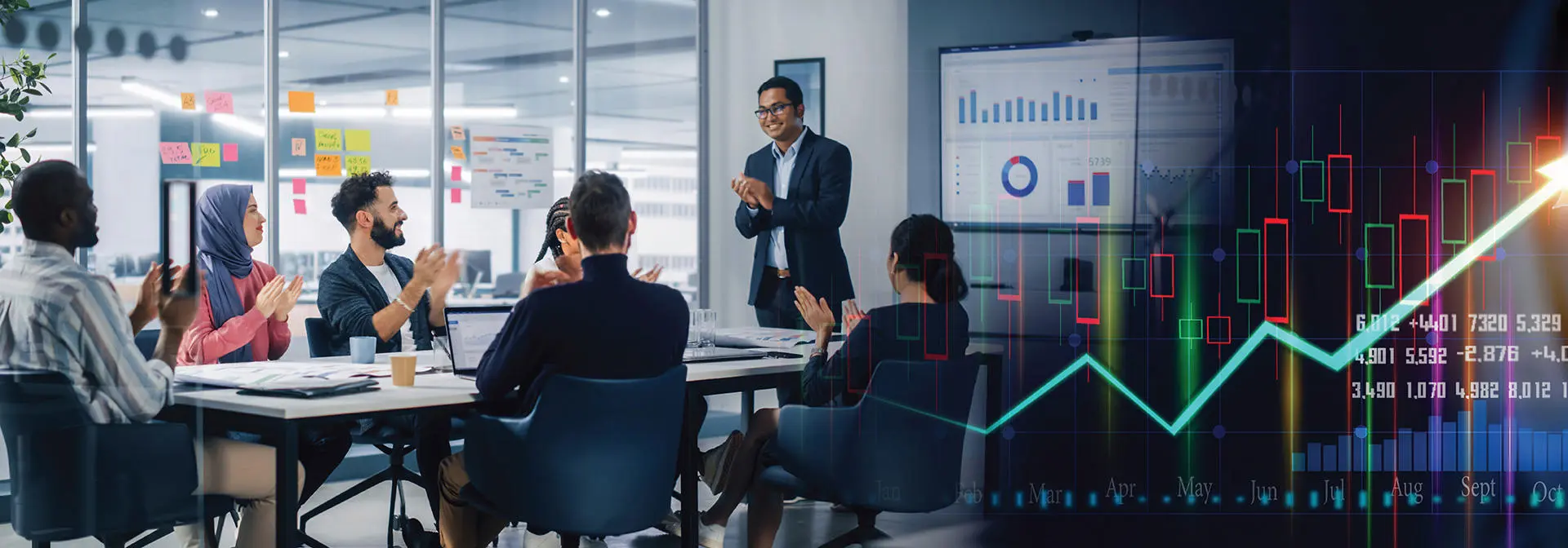 Business professionals discussing strategies in a meeting room, with a large upward graph displayed on the screen.