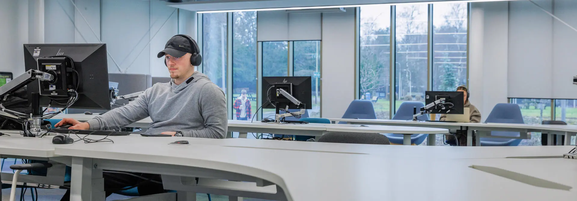 Student working on a computer in a common area